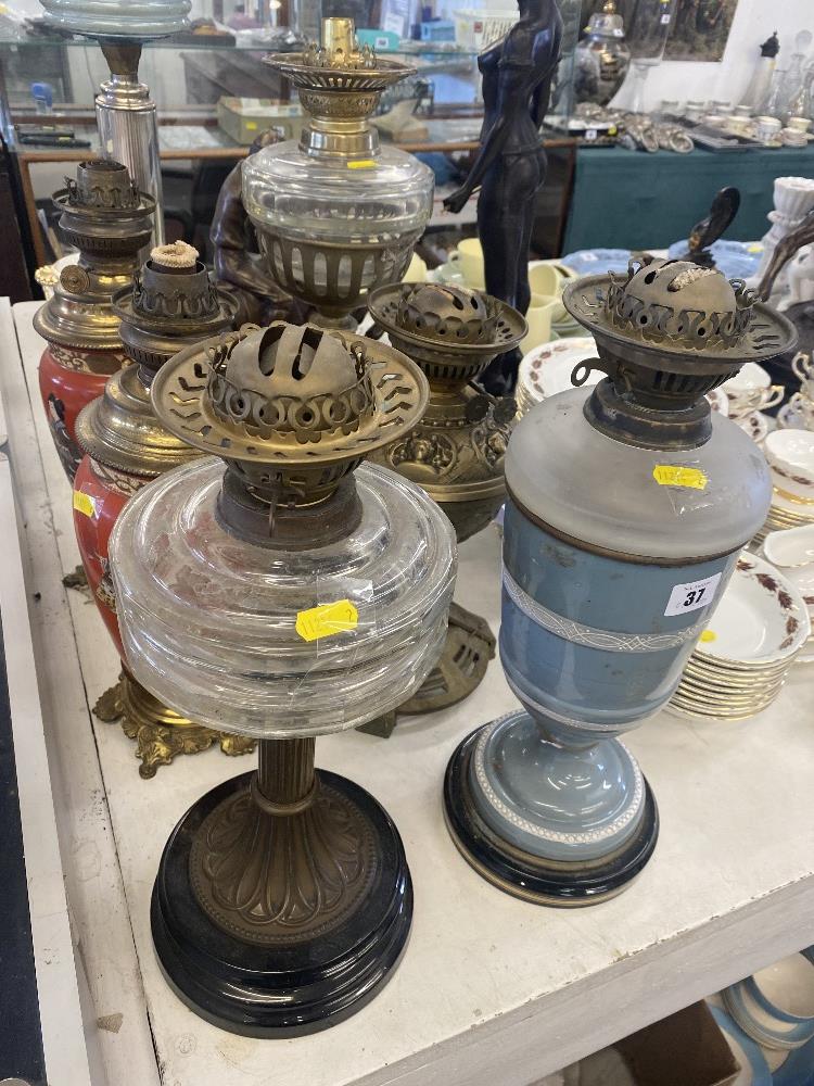 Five assorted oil lamps,