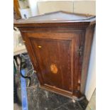 A 19th century inlaid Oak corner cupboard