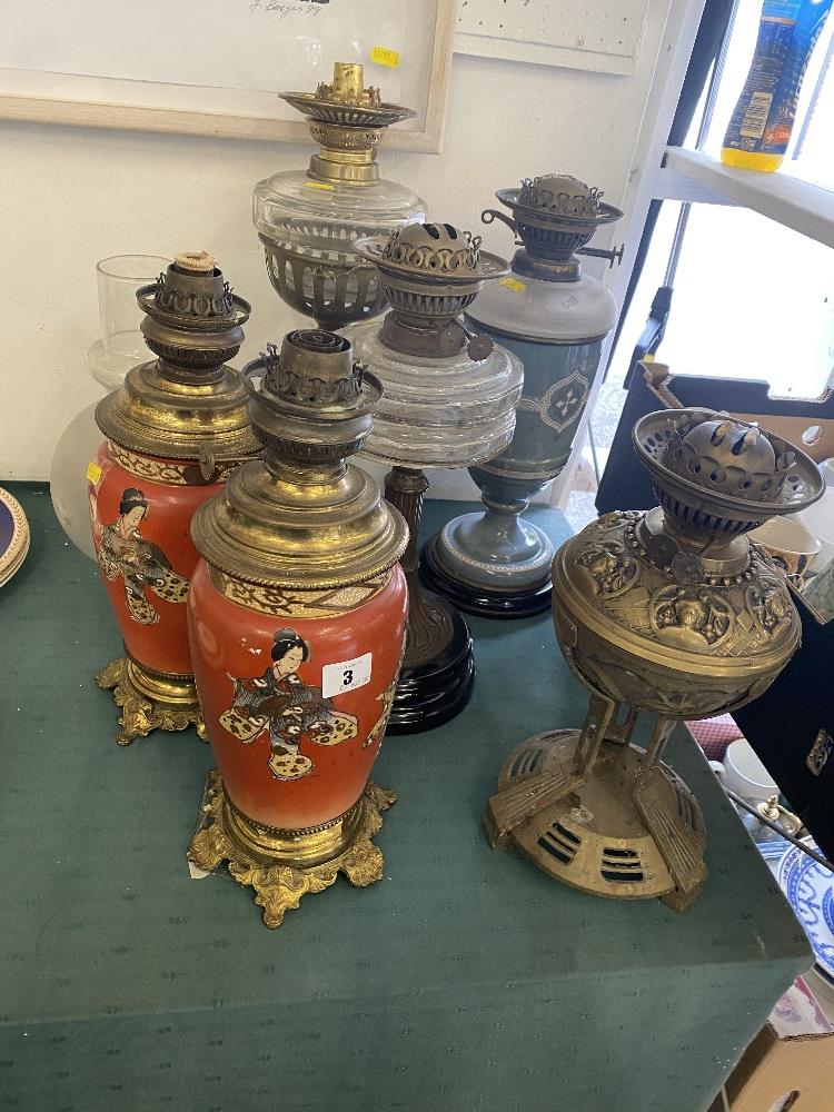 Five assorted oil lamps,