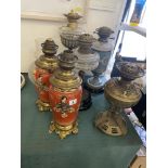 Five assorted oil lamps,