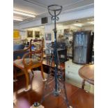 A Victorian wrought iron lamp stand