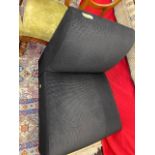 A small black upholstered chair