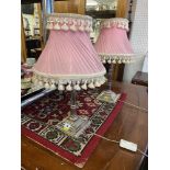 A pair of silver plated lamps