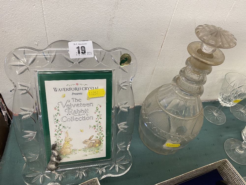 An antique Waterford decanter and a modern frame