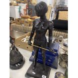 A bronze lady with cane