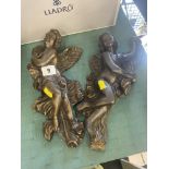 A pair of Bronze Cupid wall figures