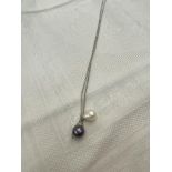 A 14ct white gold chain suspended with two Pearls,