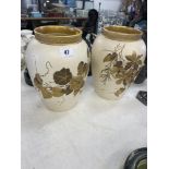 A pair of cream decorative Wedgewood vases,