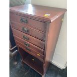 A music cabinet with fall front drawers