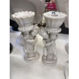 A pair of marble Cherub candlesticks