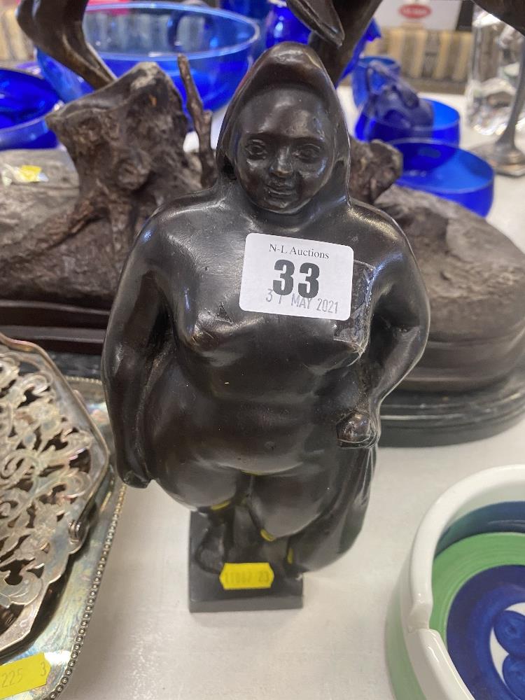 A bronze Botero style lady