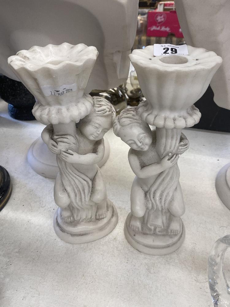 A pair of marble Cherub candlesticks