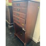 A music cabinet with fall front drawers