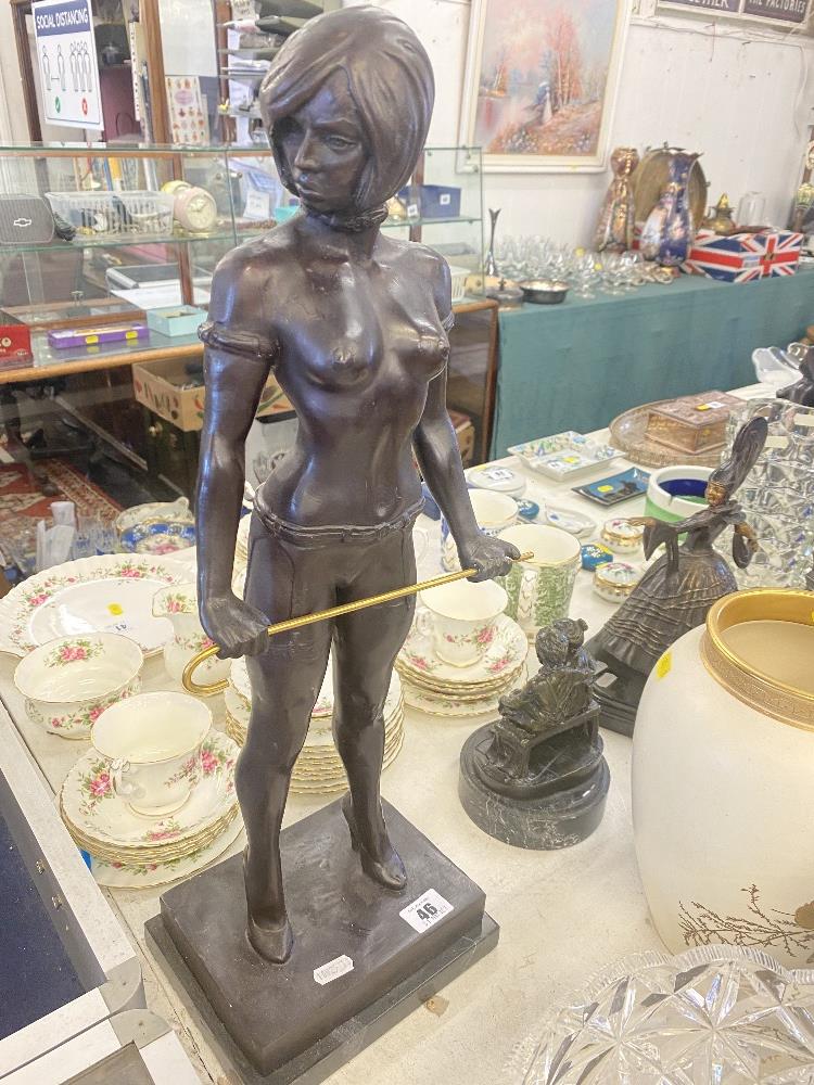 A bronze lady with cane