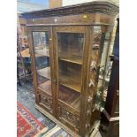 A carved Oak display cabinet