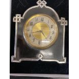 A tortoiseshell and silver clock