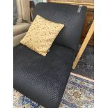 A small black upholstered chair