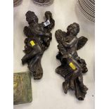 A pair of Bronze Cupid wall figures