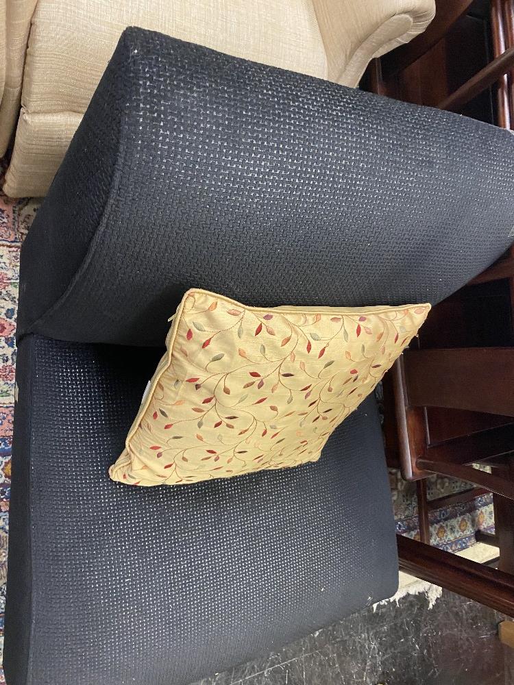 A small black upholstered chair