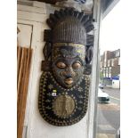 An early 20th century African wall mask embellished with copper and beads, 90cms by 40cms approx.