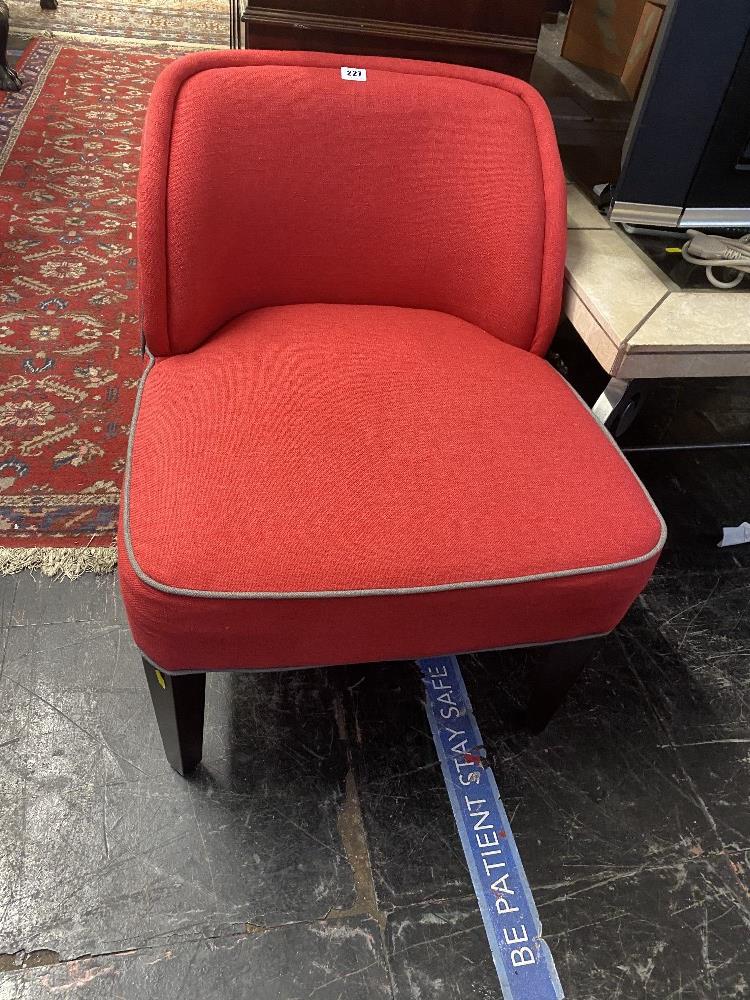 A red upholstered nursing chair