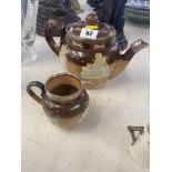 A Royal Doulton tea pot, and matching milk jug,