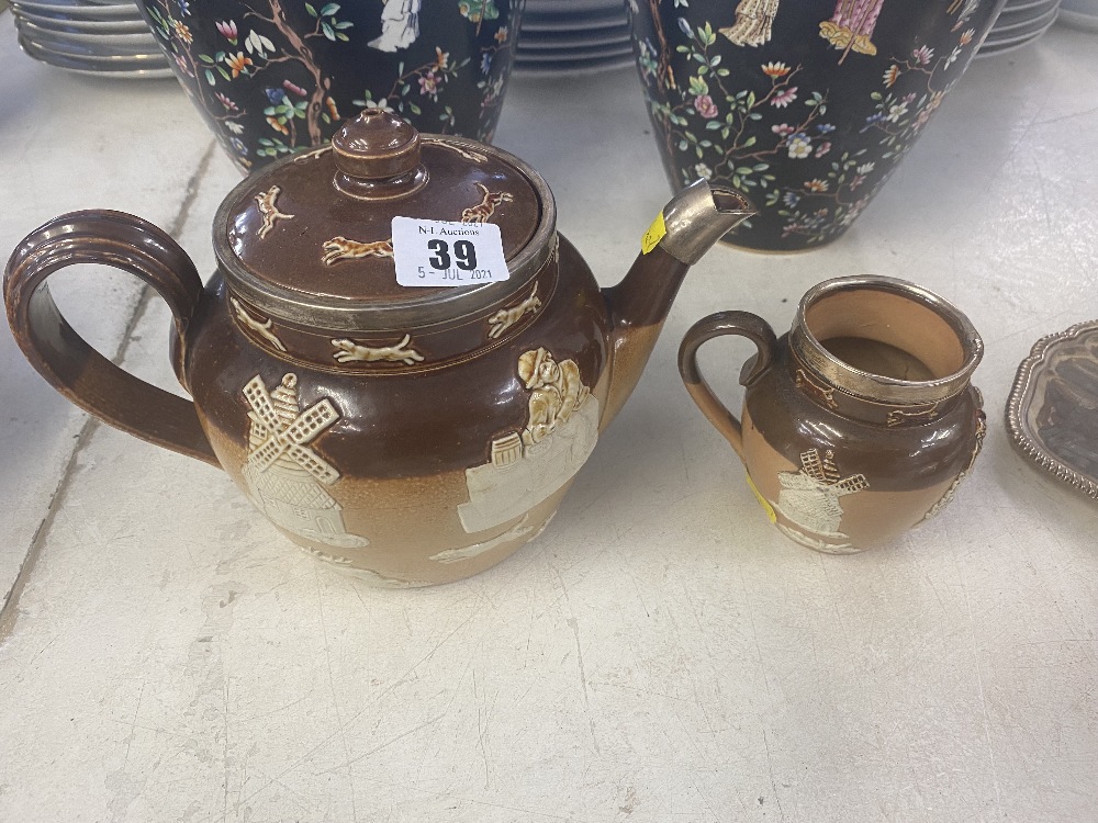 A Royal Doulton tea pot, and matching milk jug,