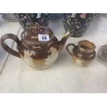 A Royal Doulton tea pot, and matching milk jug,