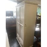 A decorative painted child's wardrobe with under drawer (two hanging rails) and matching two over