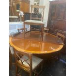 An inlaid circular dining table and leaf,