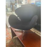 A mid-century style child's chair, black upholstery,