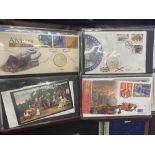 An album of first Day Covers and coins