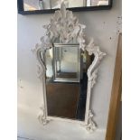 A White decorative framed mirror