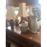 Five decorative lamps and two vases with shades