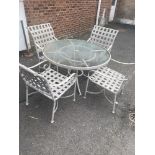 A garden glass top table and four chairs