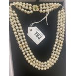 A three row cultured Pearl necklace on and 18ct Gold continental clasp set with Emeralds and