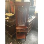 An inlaid mahogany display cabinet