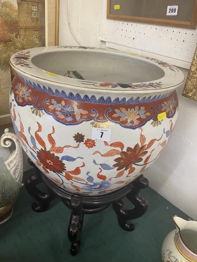 An Oriental fish bowl on stand