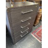 A modern five drawer chest of drawers