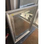 A silvered framed mirror