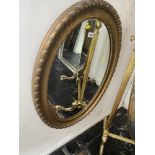 A gilt framed oval mirror