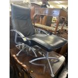 An upholstered leather reclining chair and stool