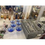 A set of six blue glasses and six tall amber glasses and a boxed pair of Champagne flutes