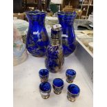 A blue glass decanter and two vases