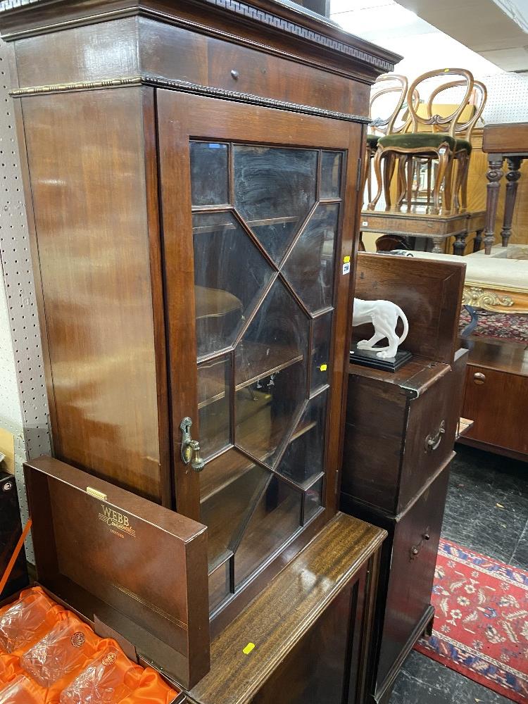 A mahogany bookcase on a cupboard base