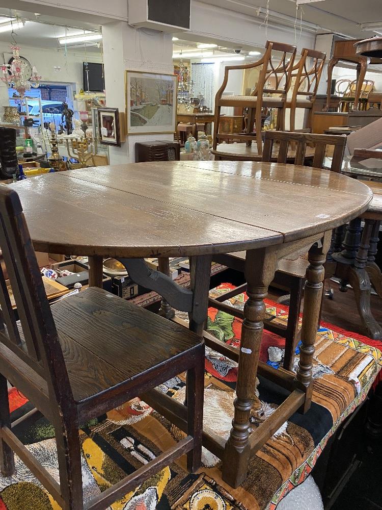 An Oak Gateleg table and two chairs