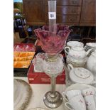 A Victorian Silver plated/ cut glass oil lamp with a Cranberry shade