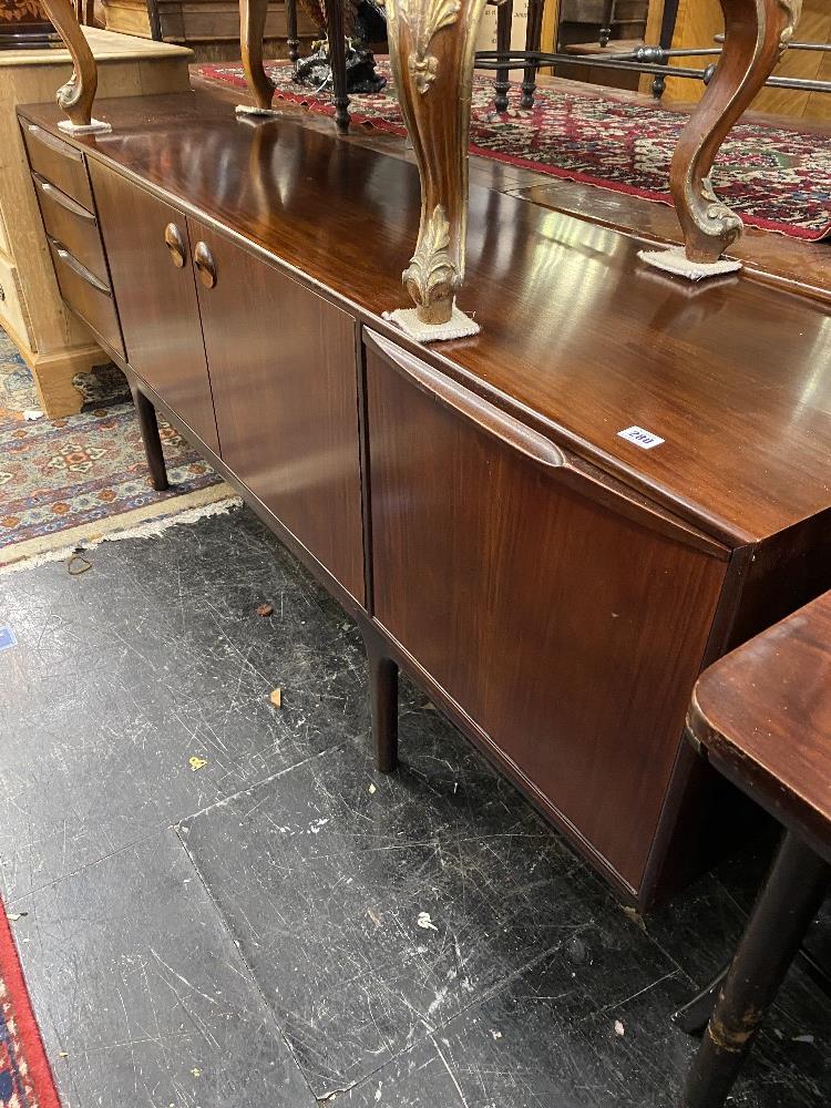 A mid century Walnut dining suite; table,