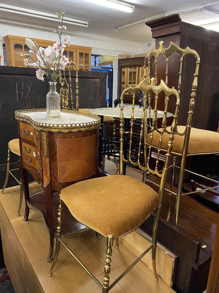 A Benaris table and four brass chairs