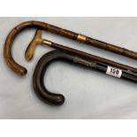 Two gold mounted walking sticks and one Silver